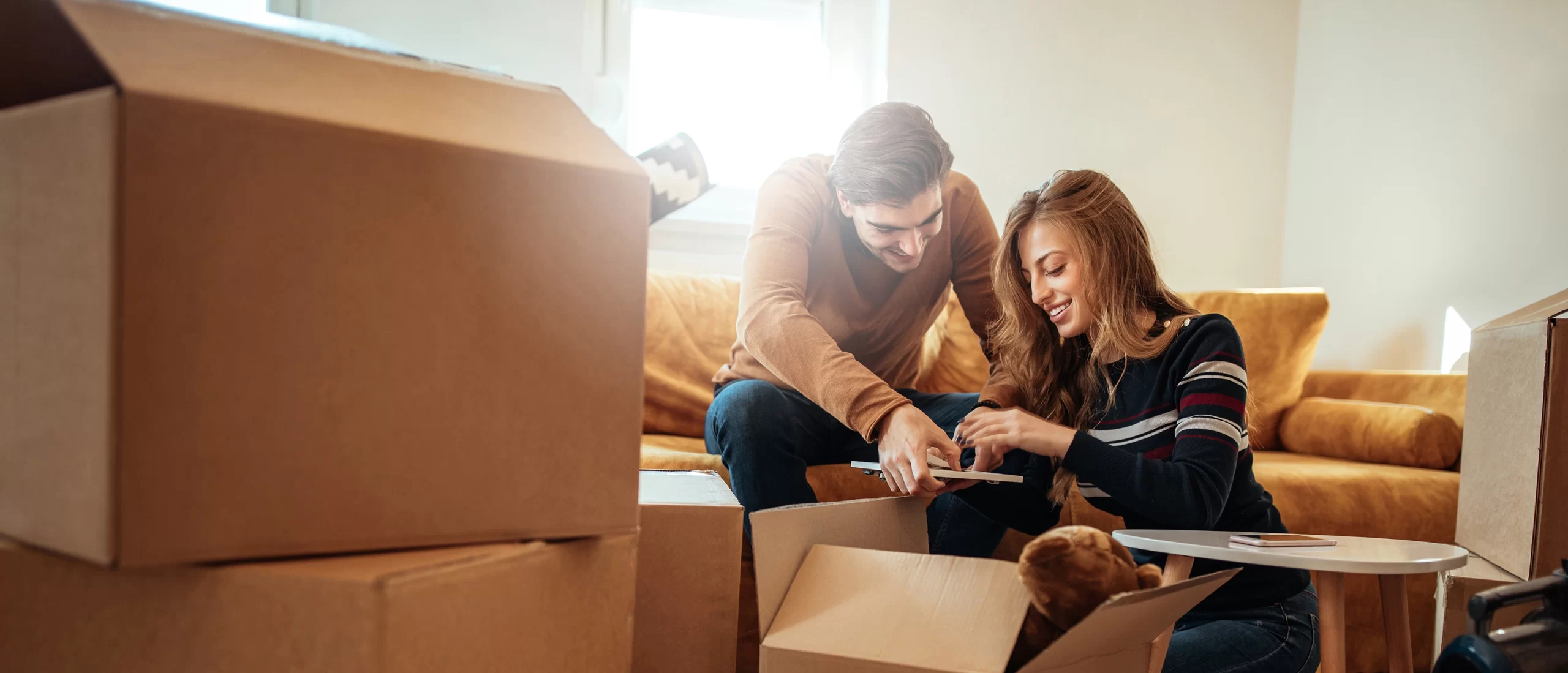 A couple packing boxes for their move